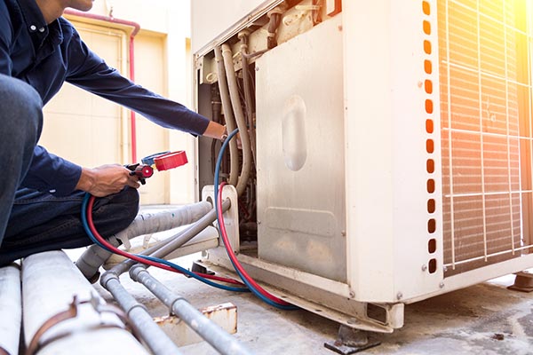 Technician checking air conditioner